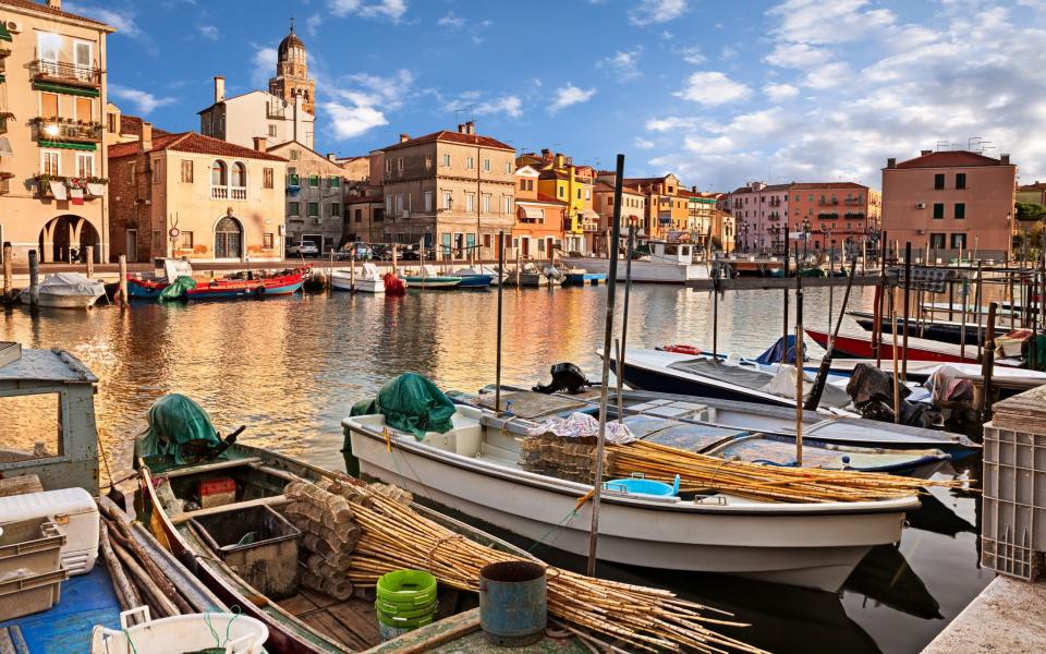 Fishing boats and old buildings in the old town of Chioggia