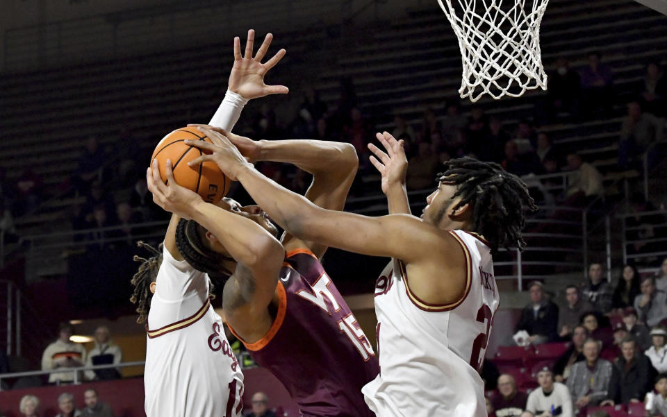 Boston College's Devin McGlockton, right, blocks a two point attempt by Virginia Tech's Lynn Kidd during the first half of an NCAA college basketball game, Wednesday, Dec. 21, 2022, in Boston. (AP Photo/Mark Stockwell)