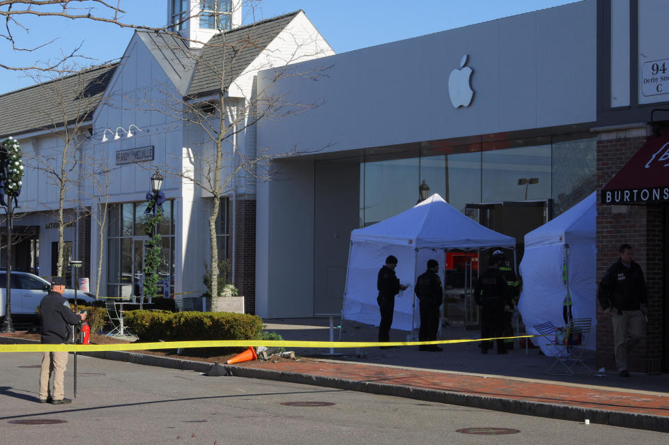 Emergency services personnel attend the scene after a vehicle crashed into an Apple store in Hingham, Massachusetts, U.S. November 21, 2022. / Credit: BRIAN SNYDER / REUTERS