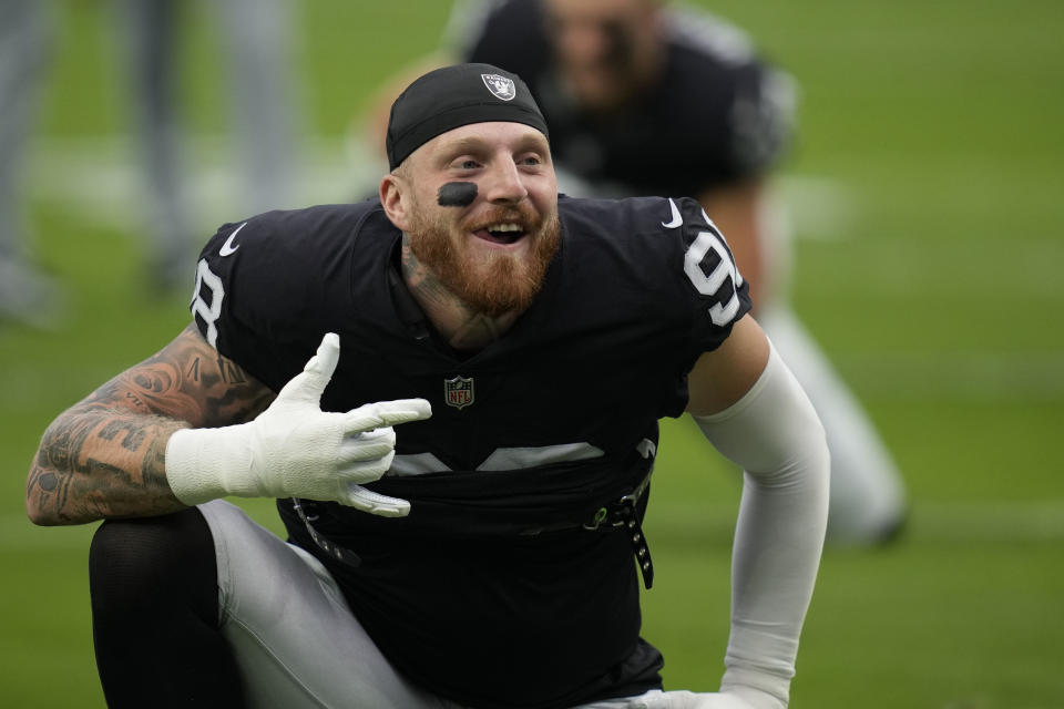 Las Vegas Raiders defensive end Maxx Crosby warms up before an NFL football game against the Arizona Cardinals, Sunday, Sept. 18, 2022, in Las Vegas. (AP Photo/John Locher)