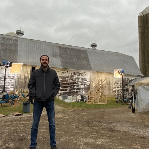 Film producer Chris Charles is seen here at the barn where a key sequence of "The Marksman," a 2021 thriller starring Liam Neeson, was filmed in Ohio. Charles wrote the screenplay, which has now been adapted into a novel, with his writing partner, Danny Kravitz.