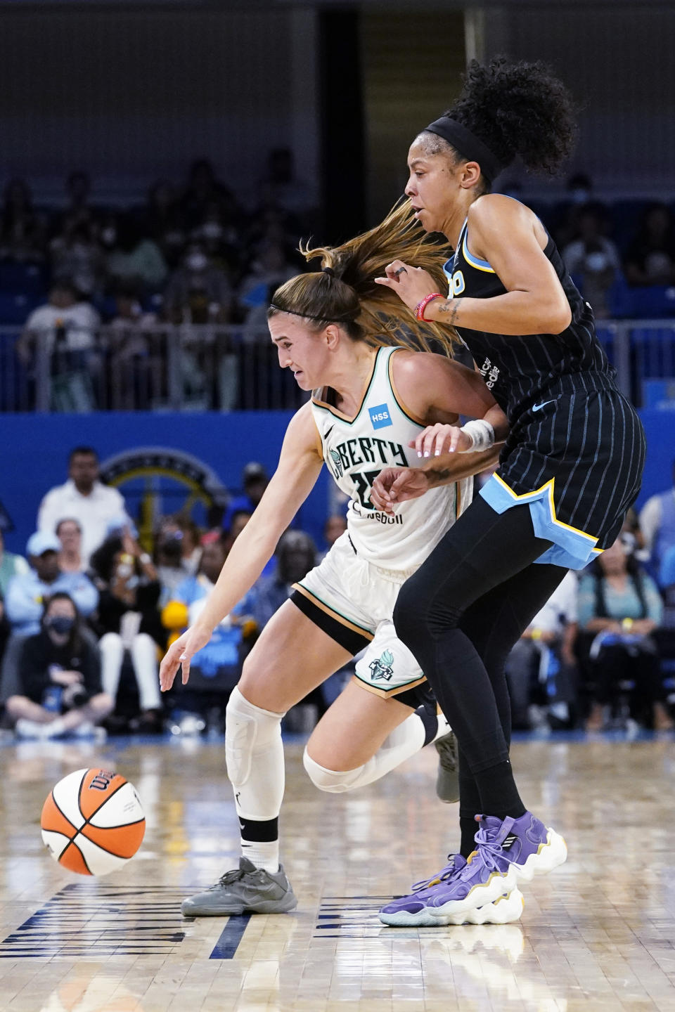 New York Liberty guard Sabrina Ionescu, left, drives against Chicago Sky forward Candace Parker during the first half in Game 1 of a WNBA basketball first-round playoff series Wednesday, Aug. 17, 2022, in Chicago. (AP Photo/Nam Y. Huh)