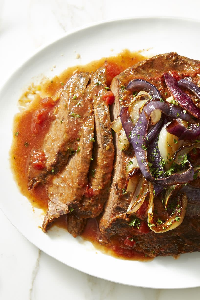 a close up of slow cooker brisket on a white plate