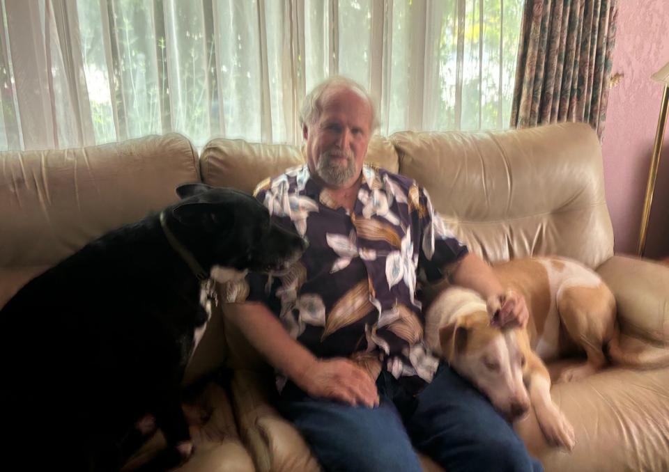 Patrick Watson, owner of Redding restaurant The Sandwichery, relaxes with his dogs.