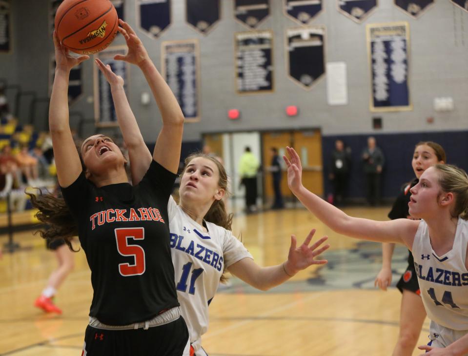 Tuckahoe's Cara Doherty wins the rebound over Millbrook's Lilly Kozera during the New York State Class C regional final on March 7, 2024.