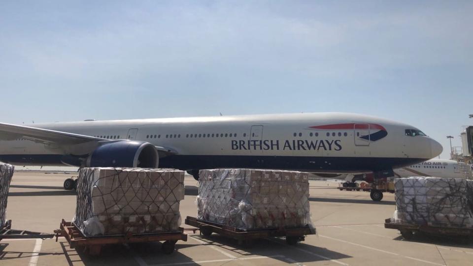 A white British Airways jet with cargo pallets waiting to be loaded on a sunny day. British Airways contributed heavily to IAG Cargo's strong Q2 cargo results.