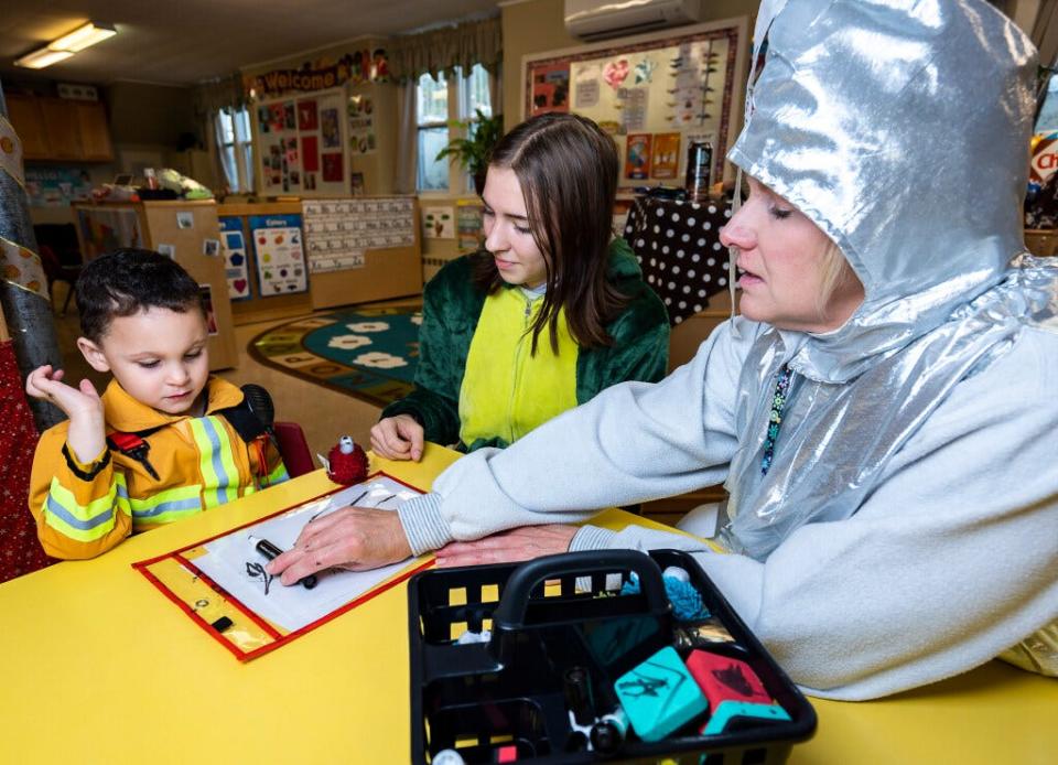 Rylee Dickinson (center), a senior at Beaver Dam High School, and Renae Henning, administrator at Community Care Preschool & Child Care Inc., conduct a writing exercise with 4-year-old Odin Paynt in the 4K class in Beaver Dam.