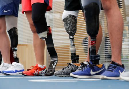 Participants wear prosthetics at an opening ceremony of a special "library" that lets people borrow and try out prosthetic "blades" for runners, in Tokyo, Japan, October 15, 2017. Picture taken October 15, 2017. REUTERS/Kim Kyung-Hoon