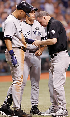 Yankees shortstop Derek Jeter (L) receives treatment for a pitch that didn't even hit him