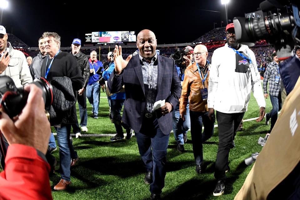 Former Buffalo Bills running back Thurman Thomas, center, leaves the field after a halftime celebration retiring his number during an NFL football game against the New England Patriots, Monday, Oct. 29, 2018, in Orchard Park, N.Y. (AP Photo/Adrian Kraus)