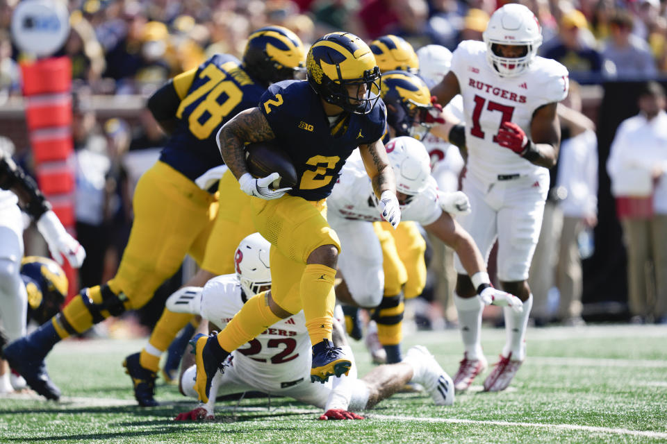 Michigan running back Blake Corum (2) runs the ball against Rutgers in the first half of an NCAA college football game in Ann Arbor, Mich., Saturday, Sept. 23, 2023. (AP Photo/Paul Sancya)