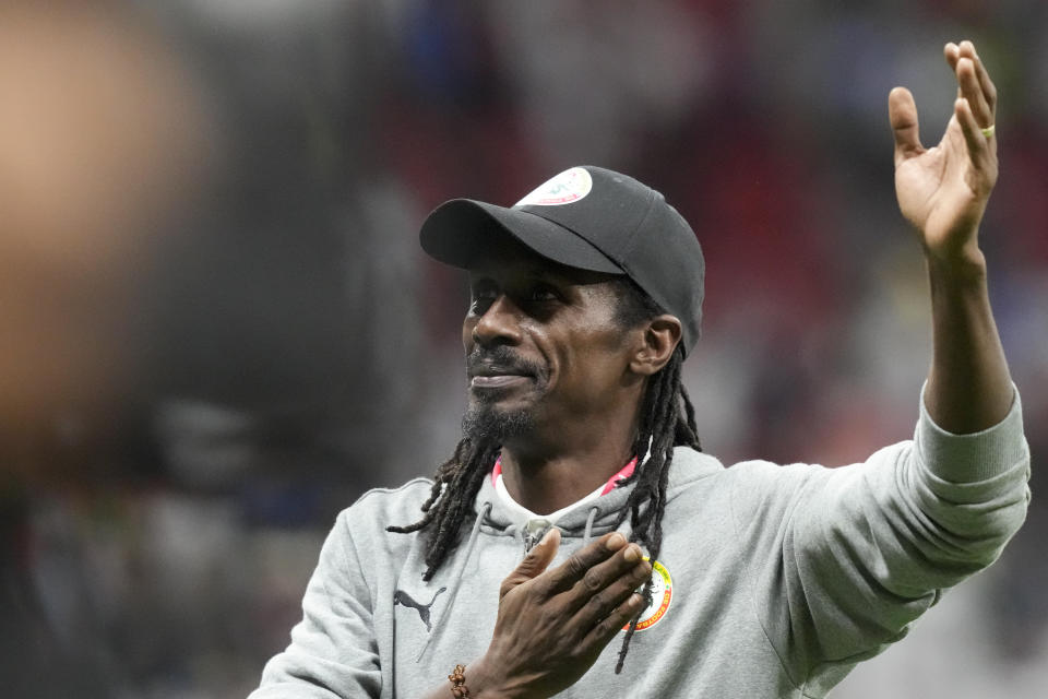 Senegal's head coach Aliou Cisse waves to fans after the World Cup round of 16 soccer match between England and Senegal, at the Al Bayt Stadium in Al Khor, Qatar, Sunday, Dec. 4, 2022. (AP Photo/Frank Augstein)