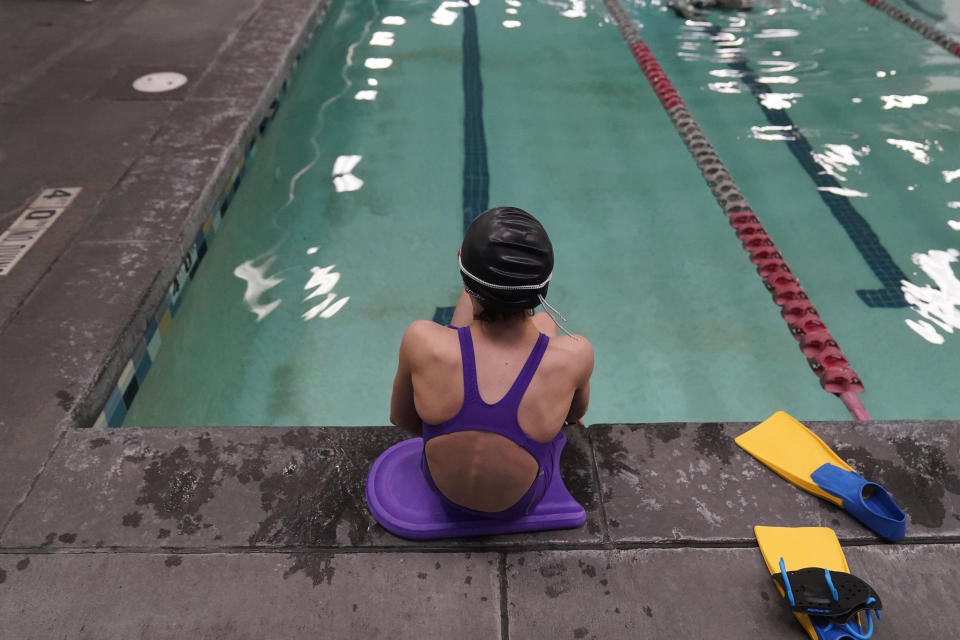 FILE - A 12-year-old transgender swimmer waits by a pool on Feb. 22, 2021, in Utah. Utah’s Republican governor on Saturday, Jan. 28, 2023, signed bills that ban youth from receiving gender-affirming health care and allow families to receive scholarships to pay for education outside the public school system, both measures that are part of larger nationwide movements. (AP Photo/Rick Bowmer, File)