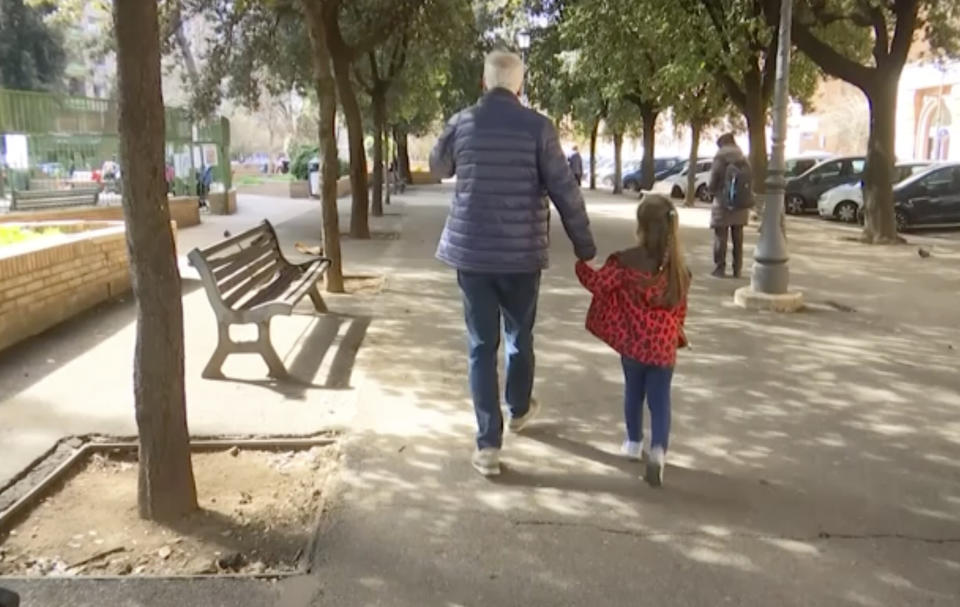 A young girl walk with her elderly grandparent along a tree lined avenue in Rome, Italy, Thursday March 5, 2020, after the Italian government closed all schools to assist in the fight against the COVID-19 virus. Some of the most vulnerable people, grandparents, have been forced to face possible virus infection as they look after young family members in playgrounds and parks in the city.(AP Photo) (Photo: ASSOCIATED PRESS)