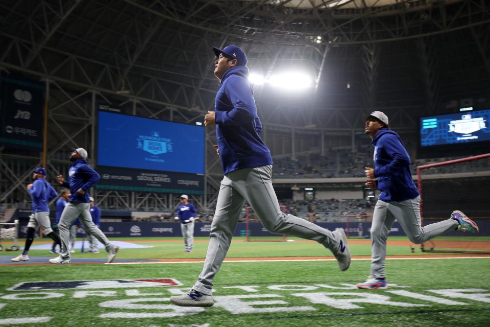 Shohei Ohtani and the Los Angeles Dodgers warm up prior to their MLB season-opening game against the San Diego Padres in Seoul, South Korea.