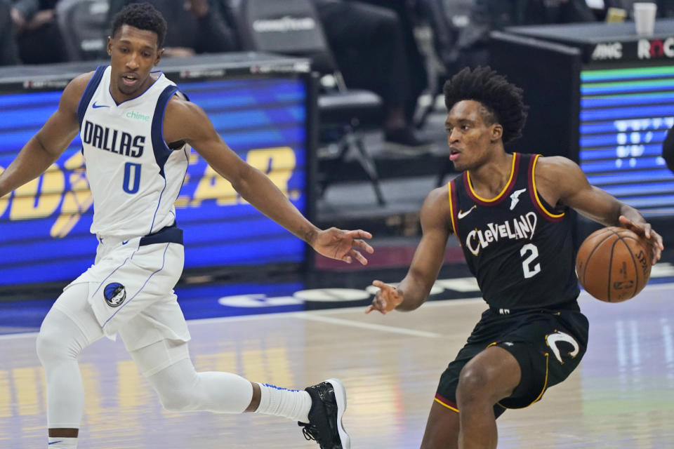 Cleveland Cavaliers' Collin Sexton (2) drives against Dallas Mavericks' Josh Richardson (0) during the first half of an NBA basketball game, Sunday, May 9, 2021, in Cleveland. (AP Photo/Tony Dejak)