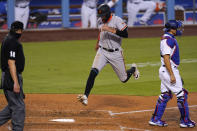 San Francisco Giants' Hunter Pence, center, scores on a sacrifice fly by Mauricio Dubon as Los Angeles Dodgers catcher Austin Barnes stands at right during the sixth inning of a baseball game Saturday, Aug. 8, 2020, in Los Angeles. (AP Photo/Mark J. Terrill)