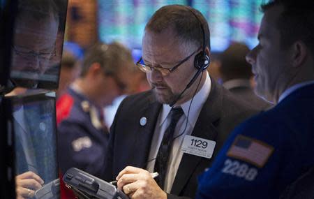 A trader works on the floor of the New York Stock Exchange in New York March 18, 2014. REUTERS/Carlo Allegri