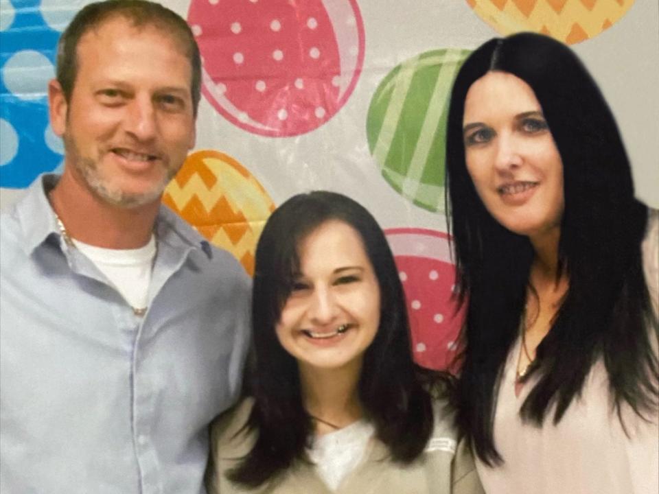 rod, gypsy, and kristy blanchard posing together in prison. gypsy is in a prison uniform in the center and they're all smiling