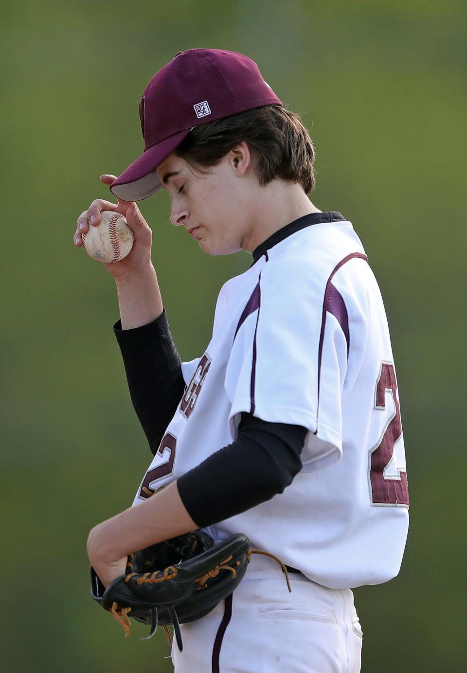 Woodridge starting pitcher Will Heisler reacts after the Coventry Comets scored run during the third inning of a baseball gam on Monday.