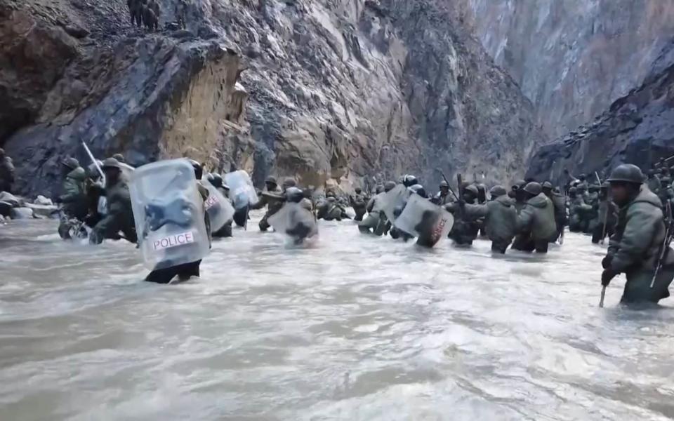 Indian soldiers crossing a river in the Galwan Valley in June last year, according to footage shown on Chinese state TV - GETTY IMAGES