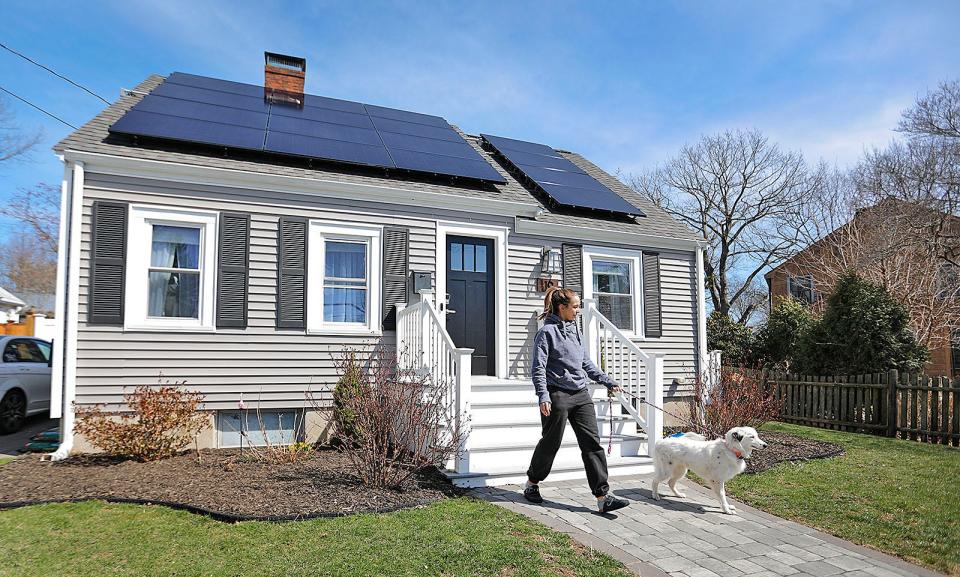 Ariel Campbell, of Quincy, takes Quinn for a walk. Campbell and her fiance, Jack Paleczny, moved from Boston to a house in Quincy, where the couple hired landscapers to spruce up their property. Tuesday, March 29, 2022.