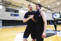 Yeshiva forward Kevin Bokor, left, celebrates a win over Worcester Polytechnic Institute with guard Max Leibowitz, right, after an NCAA DIII college basketball game that allowed no spectators on Friday, March 6, 2020, in Baltimore, Md. The game at Johns Hopkins University is believed to be the first U.S. sports event held without fans because of the new coronavirus. (AP Photo/Terrance Williams)