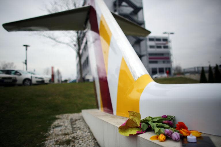 Flowers are laid in commemoration of the Germanwings plane crash victims near the Germanwings headquarters in Cologne, on March 26, 2015