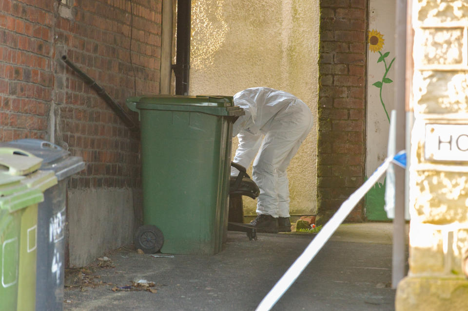 Forensic officers investigate an alleyway close to where Robert Wilson, 53, stabbed to death. (Alex Cousins/SWNS)