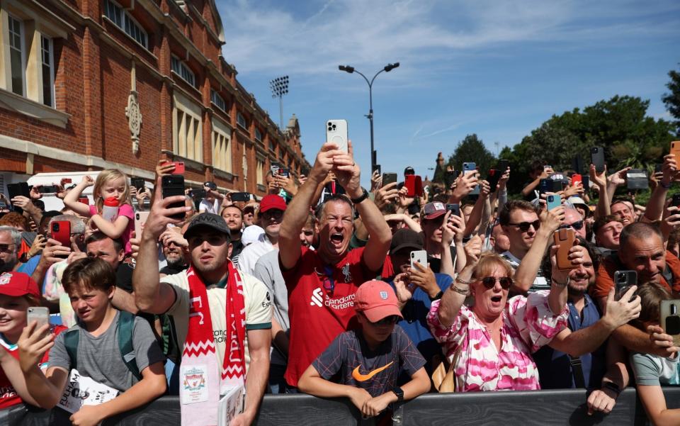 Liverpool fans react as the Liverpool team arrive prior tog the Premier League match between Fulham FC and Liverpool FC - GETTY IMAGES