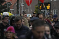 Thousand of demonstrators pass a sign urging people to respect the 1.5 meter coronavirus security measure as they march in Utrecht, Netherlands, Saturday, Dec. 4, 2021, to protest against COVID-19 restrictions and the lockdown. (AP Photo/Peter Dejong)