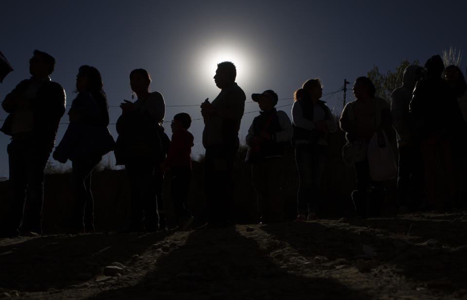 People stand in line for their chance to view the solar eclipse through a telescope in an astronomical complex at the University Mayor de San Andres in La Paz, Bolivia, July 2, 2019. (Photo: Juan Karita/AP)