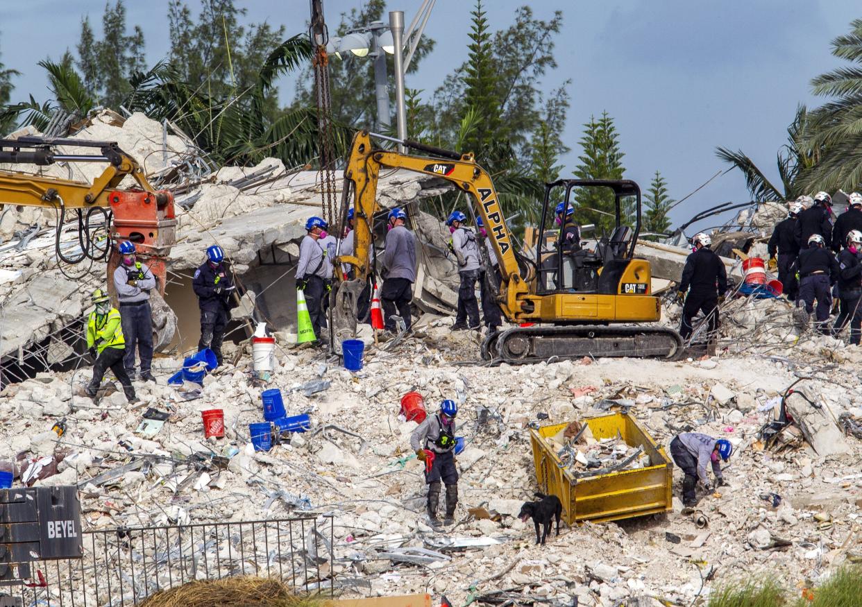 Rescuers search for victims at a collapsed South Florida condo building Monday, July 5, 2021, in Surfside, Fla., after demolition crews set off a string of explosives that brought down the last of the Champlain Towers South building in a plume of dust on Sunday.