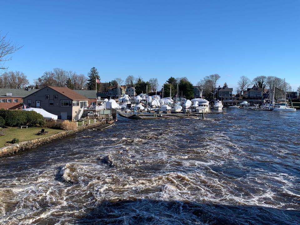 A roaring Pawtuxet River surged into Pawtuxet Cove, ripping apart a series of docks on Tuesday. The view here is from Broad Street.  [Patrick Anderson/Providence Journal]