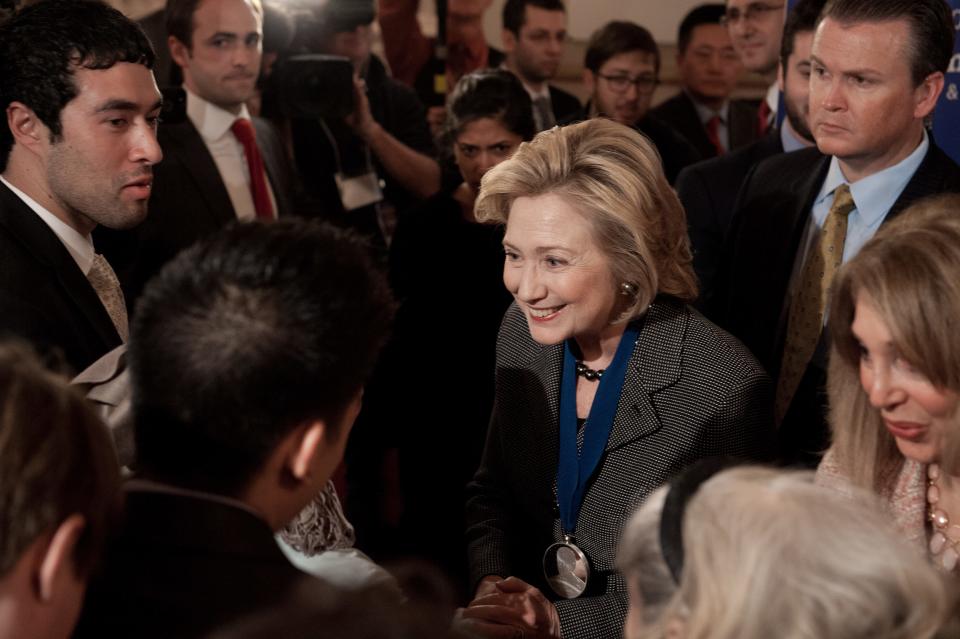 Former US Secretary of State Hillary Clinton greets well-wishers after receiving the 2013 Lantos Human Rights Prize during a ceremony on Capitol Hill in Washington on December 6, 2013.  (Photo credit should read NICHOLAS KAMM/AFP/Getty Images)