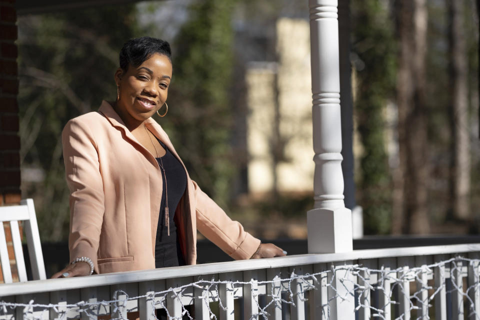 April Chapman, a small business owner, poses for a photo Tuesday, Dec. 27, 2022, at her home in Conyers, Ga. Chapman who lives in metro Atlanta switched from Democrat to Republican after the 2012 election. (AP Photo/Ben Gray)