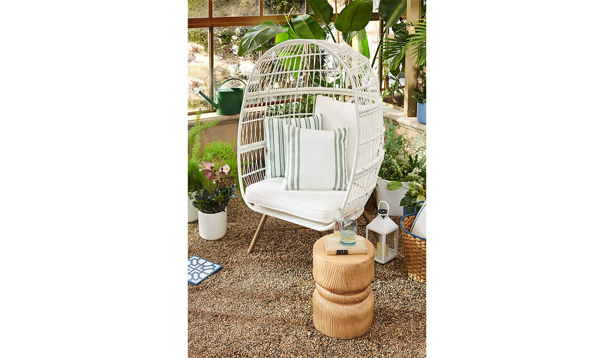 White egg chair in greenery-infused space