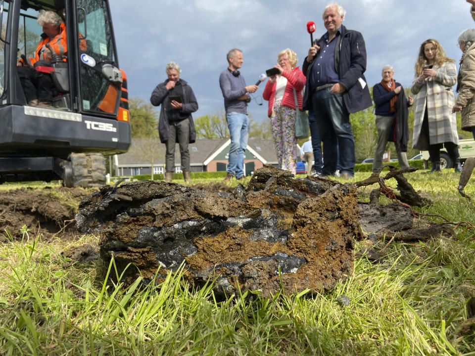 An mechanical digger on the site where the Nazi loot was reportedly buried in Ommeren, near Arnhem, The Netherlands, Monday, May 1, 2023. An officially sanctioned hunt for a stash of precious jewelry looted by the Nazis during World War II and purportedly buried in a sleepy rural Dutch village has — like many previous searches — failed to unearth any treasure. Archeologists and historians called into the village of Ommeren, about 80 kilometers (50 miles) southeast of Amsterdam, pushed a detection device called a magnetometer along a row of fruit trees and across a field Monday morning and used a mechanical digger to excavate holes in the soggy soil. (AP Photo/Aleksandar Furtula)