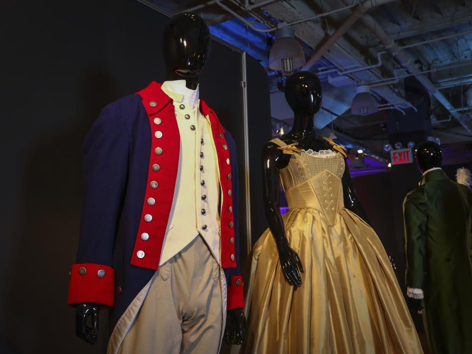 Costumes from the Broadway musical "Hamilton" are displayed at the "Showstoppers! Spectacular Costumes from Stage & Screen" exhibit, benefitting the Costume Industry Coalition Recovery Fund, in Times Square on Monday, Aug. 2, 2021, in New York. (Photo by Andy Kropa/Invision/AP)