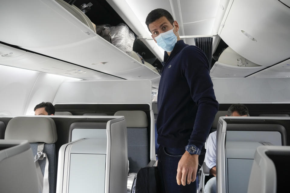 Novak Djokovic prepares to take his seat on a plane to Belgrade, in Dubai, United Arab Emirates, Monday, Jan. 17, 2022. Djokovic was deported from Australia on Sunday after losing a bid to stay in the country to defend his Australian Open title despite not being vaccinated against COVID-19.(AP Photo/Darko Bandic)