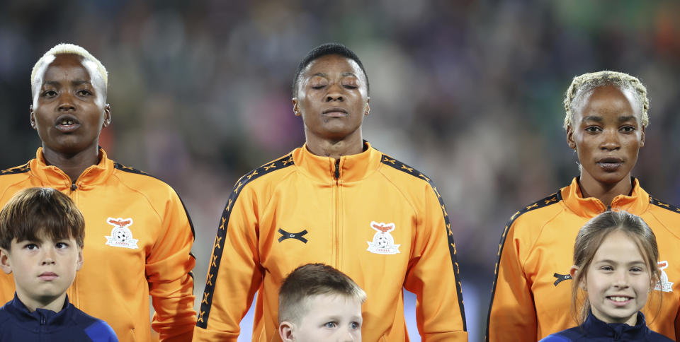 Zambia's Agness Musesa, centre, and teammates Racheal Kundananji, left, and Lushomo Mweemba sing their national anthem ahead of the Women's World Cup Group C soccer match between Zambia and Japan in Hamilton, New Zealand, Saturday, July 22, 2023.The group stage was the source of enormous national pride for Portugal, the Philippines, Vietnam, Panama, Ireland, Haiti, Zambia and Morocco, all newcomers to the highest level of international women's soccer. (AP Photo/Juan Mendez)