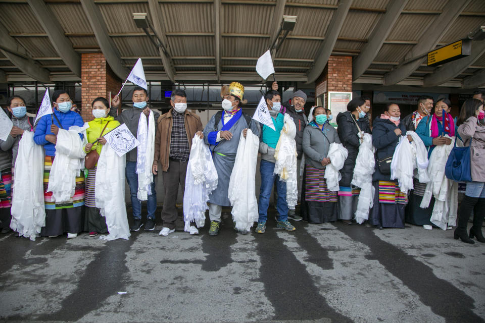 Friends and family members wait to receive the all-Nepalese mountaineering team that became the first to scale Mount K2 in winter as they arrive at Tribhuwan International airport in Kathmandu, Nepal, Tuesday, Jan. 26, 2021. (AP Photo/Niranjan Shrestha)