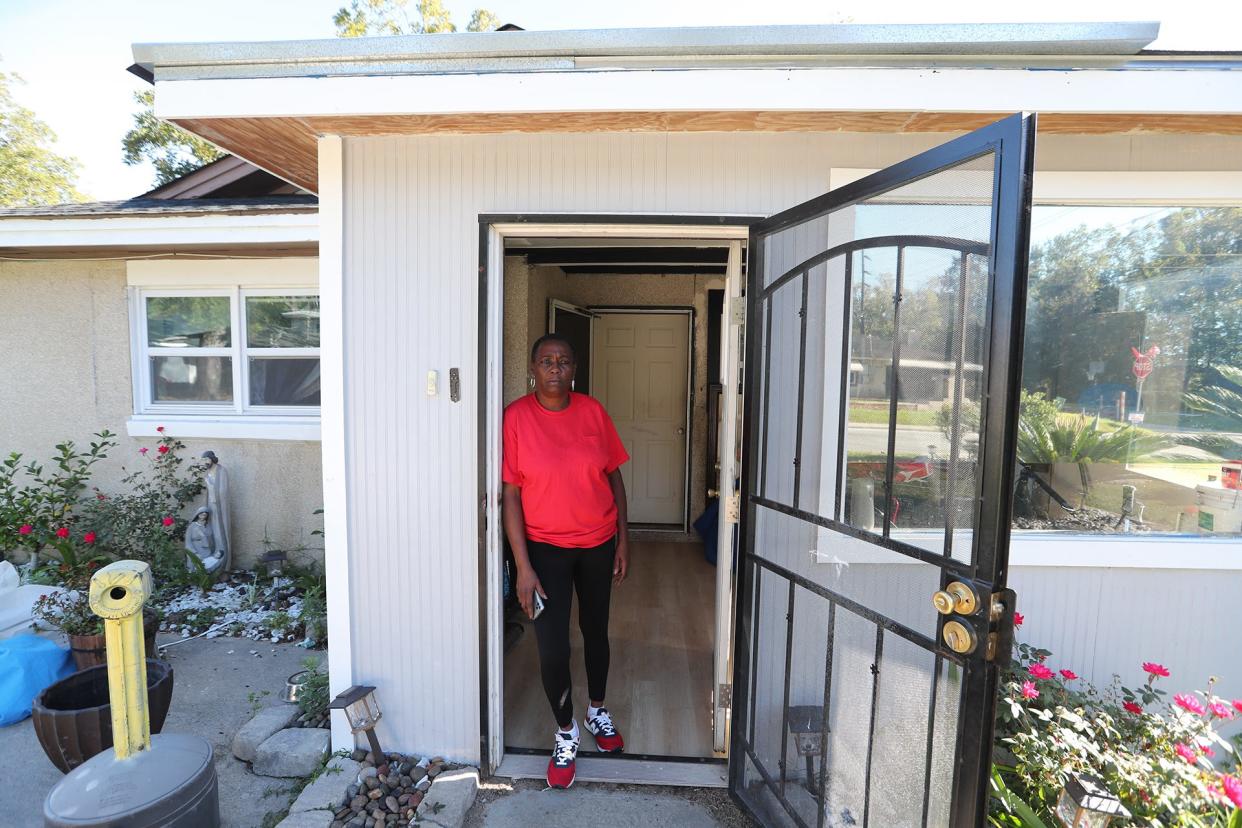 Angela stands in the doorway of her Garden City home. Work was done on her home through a special grant but was not completed and in some cases not done properly.