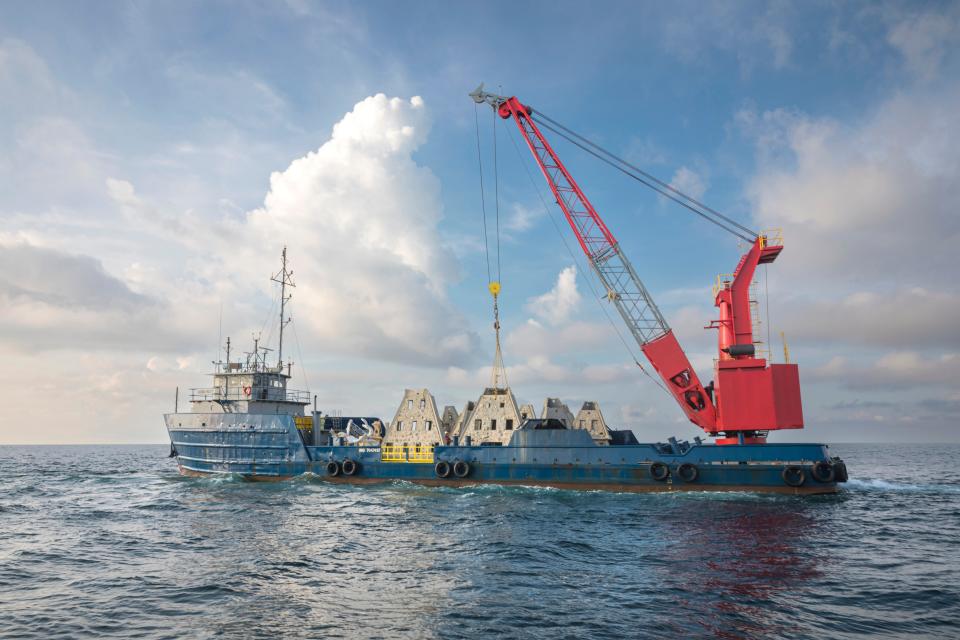 A crane lifts one of several artificial reef structures that were deployed recently in the Gulf of Mexico about 5.75 nautical miles southwest of Destin.