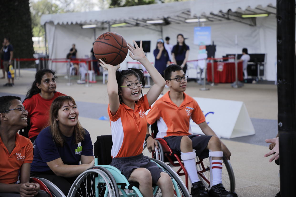 Participants playing wheelchair basketball at the Let’s Play! carnival at PAssion WaVe@Marina Bay. (PHOTO: People’s Association Water-Venture)