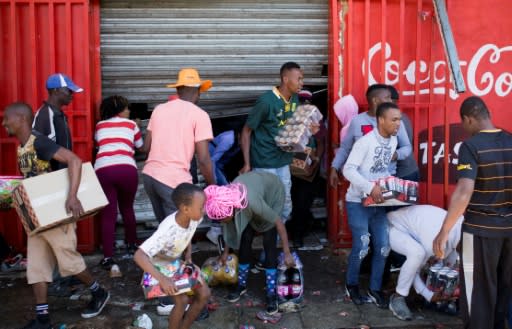 Looters stole items from shops they believed to be foreign-owned during a riot in a Johannesburg suburb