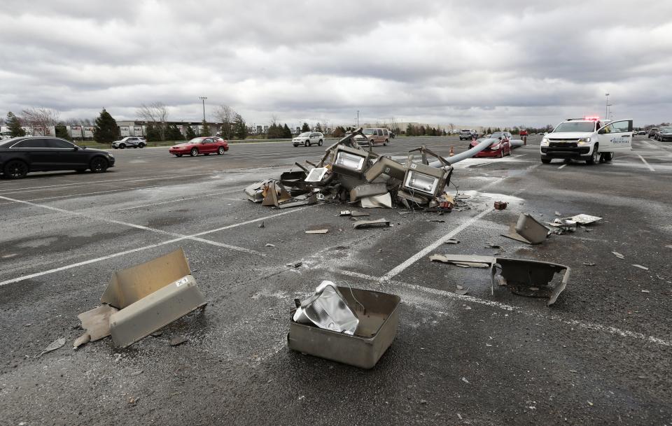 A car was damaged after high winds blew over a light pole in the parking lot at GE Appliance Park in Louisville, Ky. on Mar. 3, 2023.   