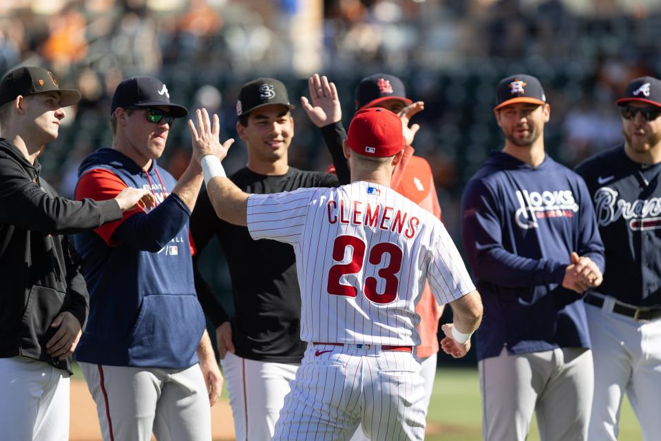 Philadelphia Phillies infielder Kody Clemens high-fives Atlanta Braves pitcher Bryce Elder as Houston Astros pitcher Blair Henley (right) looks on before the annual Texas Alumni baseball game in Austin, Texas on Saturday, Feb. 3, 2024. The Texas team beat the alumni 7-4.
(Credit: Angela Wang/Special to American-Statesman)