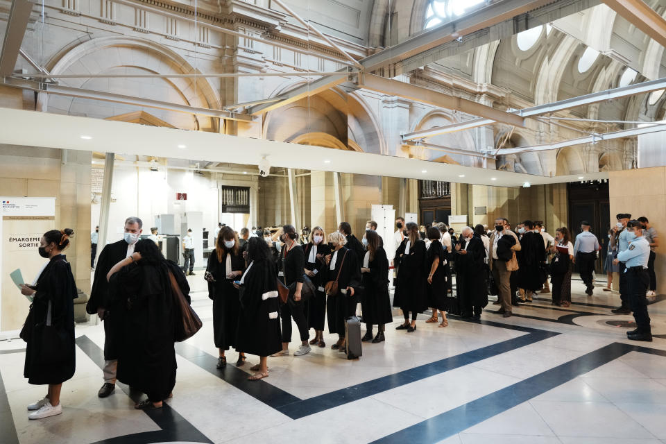 Lawyers and participants arrive at the special courtroom Wednesday, Sept. 8, 2021 in Paris. In a secure complex embedded within a 13th-century courthouse, France on Wednesday will begin the trial of 20 men accused in the Islamic State group's 2015 attacks on Paris that left 130 people dead and hundreds injured. (AP Photo/Thibault Camus)