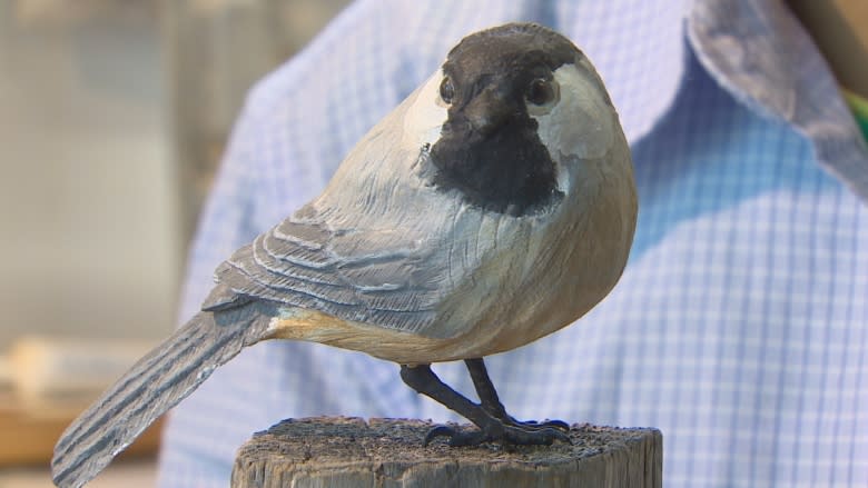 Young Syrian crafts wooden birds in Harvey Station